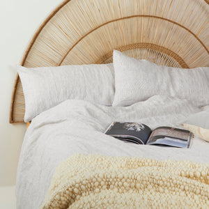 Bedroom ambience with stonewashed linen bedding in gray and white.