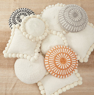 Group photo Salta cushion with pom poms.