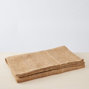 Hand-woven wool rug "Chaco" folded. Stylishly rustic, vibrant & intense. Hand woven by expert weavers in Argentina, this pure sheep wool rug is a unique designer piece that combines softness and warmth with the positive energy of sustainability. Colours: Beige/Honey/Tobacco Sizes: 160 x 200 cm, 200 x 300 cm - Discover now at BY NATIVE in our online shop.