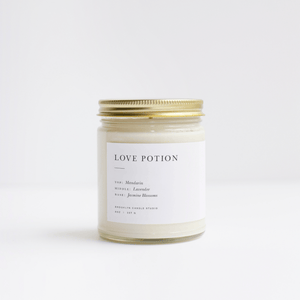 Love Potion scented candle in a jar with lid and notes of jasmine, lavender and mandarin