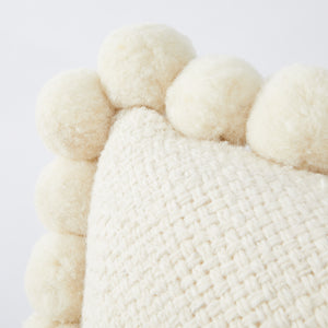 Hand-woven wool cushion PomPom detail